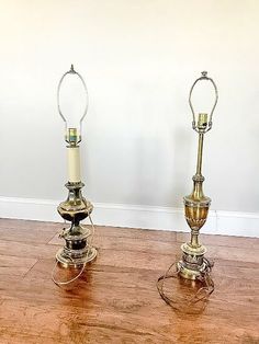 two lamps sitting on top of a wooden floor