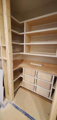 an unfinished closet with shelves and drawers