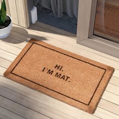 a door mat with the words mi, i'm mat on it next to a potted plant