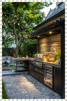 an outdoor kitchen is lit up at night