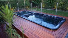 a hot tub sitting on top of a wooden deck