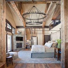 a large bed sitting in a bedroom on top of a wooden floor next to a fire place