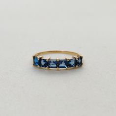 This stunning ring is set in 14k Solid Yellow Gold with Natural London Blue Topaz with utmost precision. It is an unique statement gemstone ring for nearly every occasion and is completely hassle-free jewelry. ITEM DETAILS *  GEM: London Blue topaz * GEM SIZE: 3mm * GEM SHAPE: Square 6pcs * Gem weight: 1.20 carats * Gold Purity: 14KT * Gold Weight: 1.17 gram * Total Weight of the Ring: 1.41 gram The Gold purity is guaranteed and it comes with authentic 14KT gold hallmark. Since my items are handmade, they are absolutely nickel and lead free. CUSTOMIZATION: * Size Customization is available for this ring and it is available in all ring sizes. Kindly choose your ideal ring size from the drop-down. * Gemstone customization is available and the it can be substituted with a gem of your choice. Blue Topaz Ring With Prong Setting In 14k Gold, Blue Emerald Cut Topaz Ring In 14k Gold, Blue Emerald-cut Topaz Ring In 14k Gold, Blue Topaz 14k Gold Promise Ring, Blue Topaz Jewelry, Handmade Jewelry Box, Topaz Jewelry, London Blue Topaz Ring, Solid Gold Rings