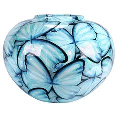 a glass vase with blue butterflies painted on it