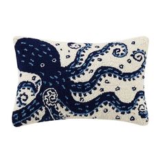 an embroidered pillow with an octopus on the front and blue, white and black design