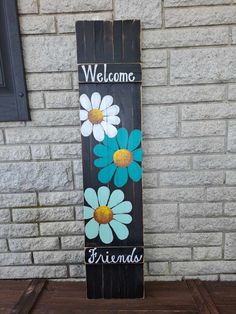 a wooden sign with flowers painted on it that says welcome to the family and friends