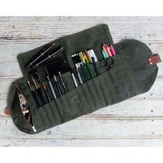 an army green pencil case filled with pens and markers