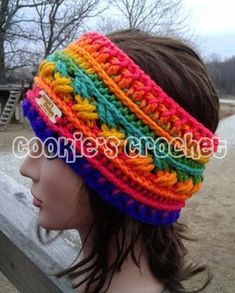 a woman wearing a colorful headband on top of a wooden bench