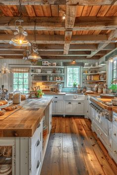 an old fashioned kitchen with wooden floors and white cabinets, wood flooring and exposed beams