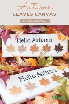 two autumn leaves with the words hello autumn on them