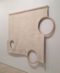 a piece of art hanging on the wall with two circles in it's center