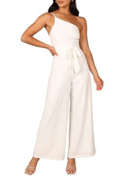 Elevate your special-occasion style with this asymmetric jumpsuit featuring a tie belt and a flowy, wide-leg silhouette. Hidden back-zip closure Asymmetric neck Adjustable strap Removable tie belt Partially lined 95% polyester, 5% spandex Hand wash, dry flat Imported Chic Strapless Jumpsuit With Tie Waist, Elegant Strapless Halter Neck Jumpsuit For Spring, Elegant Halter Neck Strapless Jumpsuit For Spring, Spring Evening Strapless Wide Leg Jumpsuit, One-shoulder Jumpsuits And Rompers For Spring Date Night, Elegant Belted Jumpsuits And Rompers For Summer, Spring Party Jumpsuits With Tie Waist, Summer Party Jumpsuits And Rompers With Tie Waist, Chic Strapless Maxi Jumpsuit For Spring