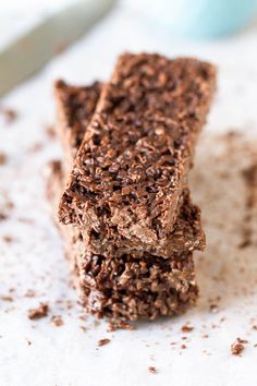 two pieces of chocolate brownie sitting on top of a table