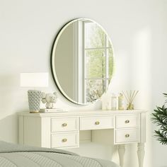 a bedroom with a white dresser and mirror