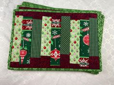 Add some color to your Christmas dining table with this set of four placemats made with upcycled fabrics. This set measures 18" by 12" and they are ready to ship today! A great housewarming gift idea around the holidays with the red and green colors! Please look over the photos. I put together a combination of fabrics that were left over from other projects. The deep cherry reds and greens jst seemed to shout "Merry Christmas! On the flip side is a tone on tone red print that could be used year round. Laundry care tips - wash in cold water with a gentle cycle then tumble dry on low for ten minutes. Lay them out flat to finish drying. I like to ship the same day you place your order if at all possible. There are more holiday table linens and sets that can be used for every day also listed i Christmas Dining Table, Fabric Placemats, Place Mats Quilted, Unique Housewarming Gifts, Green Quilt, Christmas Dining, Great Housewarming Gifts, Modern Christmas, Linen Placemats