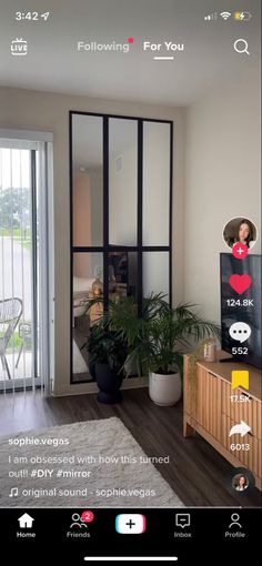 an image of a living room with sliding glass doors and plants on the side table