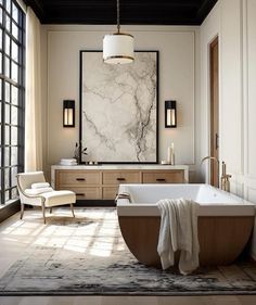 an elegant bathroom with marble and wood accents