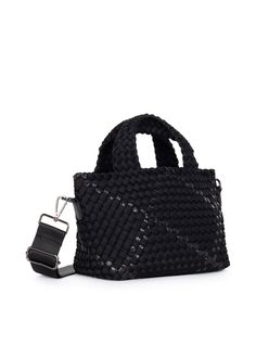 The Haute Shore Mark Noir is a small sized terylene woven tote featuring a black body with metallic accents. Woven textile body with white and olive accents. Lined interior. Top zipper closure. One slip, and one interior zip pocket. 4 inch main handle strap drop. Includes a removable wristlet pouch w/zipper and hand strap. Includes a 2 inch fully adjustable crossbody strap. Dimensions: 14" long x 8" tall x 4" deep. Washable with mild soap. Hang dry. Black Woven Shoulder Bag With Double Handle, Black Double Handle Woven Shoulder Bag, Black Woven Bag For On-the-go, Black Woven Leather Shopping Bag, Black Woven Leather Shoulder Bag For On-the-go, Black Woven Satchel For Travel, Black Rectangular Satchel With Woven Leather, Black Woven Satchel Shoulder Bag, Black Woven Leather Top Handle Shoulder Bag