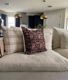 a couch with pillows on it in a living room