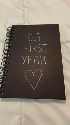 a black notebook with the words our first year written on it