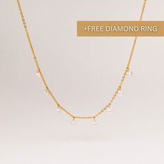 DIAMOND DROPLET STATION NECKLACE ∙DETAILS Length: 17'' / 42cm (adjustable) Diamond drop size: 5mm x 5mm ∙MATERIALS High-quality stainless steel, plated with 18k gold. A+ quality CZ diamonds. ∙Free Diamond Eternity Ring will be automatically packed to eligible orders until 22nd of May. You don't have to add Eternity Ring to cart. Please send us a message indicating what ring size you want. Available sizes: US: 5,6,7,8 If you don't send a message, we will send a size 7 ring. ∙SHIPPING IMPORTANT: before placing an order, please double check that your address is correct to avoid any delays. Shop more one-of-a-kind pieces: https://www.etsy.com/shop/SeraphinJewelry Thank you so much for visiting and hope you enjoy shopping with us ♡ -Seraphine ♡ All images are copyrighted by SeraphinJewelry. All Minimalist Bridal Necklace For Anniversary With Delicate Chain, Minimalist Bridal Necklace With Delicate Chain For Anniversary, Dainty Drop Necklace For Anniversary, Delicate Dangle Chain Necklace For Wedding, Minimalist Drop Diamond Necklace Gift, Minimalist Drop Necklaces For Anniversary, Dainty Drop Necklace With Delicate Chain For Anniversary, Anniversary Drop Necklace With Delicate Chain, Teardrop Diamond Necklace With Delicate Chain For Wedding