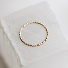 You can never have too many stackers! The Twist Ring is the loveliest solid gold rope you ever did see that is twisted into the perfect little ring. This ring wears beautifully included in a stack or by itself and makes for one of the daintiest and most versatile pieces you can dream up. As simple as the Twist Ring is, it can add just the right touch of flair to your stack and can bring the sweetness you've been looking for to your personal collection. Modern Twist Stackable 14k Gold Midi Rings, Twisted Stackable Promise Rings, Twisted 14k Gold Rings With Modern Twist, Modern Twist Yellow Gold Twisted Stackable Rings, Modern Twist 14k Gold Twisted Ring, Yellow Gold Twisted Stackable Jewelry, 14k Gold Twisted Rings For Gift, 14k Gold Twisted Promise Ring, Minimalist Twisted Yellow Gold Ring