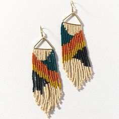 two pairs of earrings with multicolored beads hanging from the end of each ear