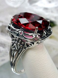 Red Ruby Ring Victorian Oval Collectible Rings, Antique Oval Ruby Ring With Filigree, Antique Oval Ruby Ring With Filigree Details, Gothic Oval Wedding Ring, Gothic Oval Gemstone Rings, Gothic Gemstone Rings With Oval Shape, Ornate Oval Ruby Ring With Intricate Design, Vintage Silver Ruby Ring With Intricate Design, Collectible Oval Ruby Ring In Silver