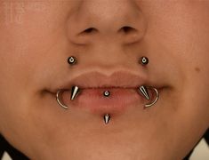 a woman with three piercings on her nose