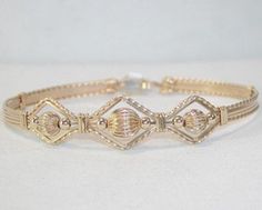 A classy design of 14kt gold filled fluted beads in 14kt gold filled wire. Dress up your favorite cocktail-hour outfit! It's affordable, it's stackable with many of my other wirewrapped bracelets, and it's sure to get noticed! The built-in hook and eye-type clasp is easy to get on and off by yourself. Choose the correct size for a perfect custom fit! Gold Wire Wrapped Metal Bracelets, Unique Gold Wire Wrapped Bracelets, Elegant Gold Wire Wrapped Cuff Bracelet, Elegant Gold Wire-wrapped Bracelet, Yellow Gold Wire Wrapped Bangle, Decoupage Jewelry Box, Handmade Jewlery, Wire Wrapped Jewelry Diy, Wire Wrapped Jewelry Tutorials