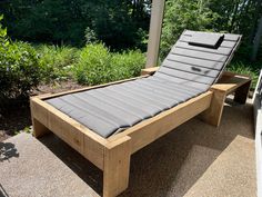 a wooden bed sitting on top of a patio