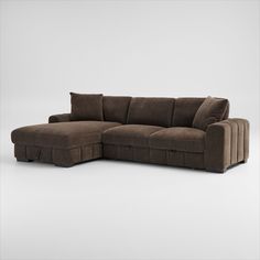 a brown sectional sofa sitting on top of a white floor