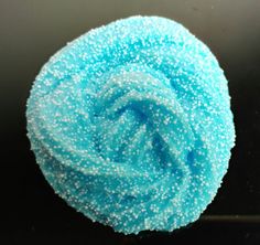 a blue sponge sitting on top of a black surface