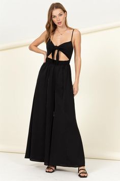 Elevate your party look or update your vacation clothes! Lightweight fabric makes up this sexy jumpsuit that has a bow tied front, connecting the two sides and leaving a sexy cut out detail. A high waist transitions into wide pant legs for a look that you'll love.Model is wearing a small, Height: 5'9", Bust: 34C, Waist: 24", Hips: 35" 100% Polyester, Stretch fabric, Non-sheer fabricCare Instructions: Machine wash cold, gentle cycle, tumble dry low. Chic High Waist Jumpsuits And Rompers, Chic Wide Leg Beach Jumpsuits And Rompers, Chic Wide-leg Beach Jumpsuits And Rompers, Backless Jumpsuit With Tie Back For Night Out, Chic Vacation Jumpsuits And Rompers With Tie Waist, Backless Tie-back Jumpsuit For Night Out, Chic Wide Leg Jumpsuits And Rompers For Beach, Chic Wide-leg Jumpsuits And Rompers For The Beach, Summer Party Wide Leg Jumpsuits And Rompers