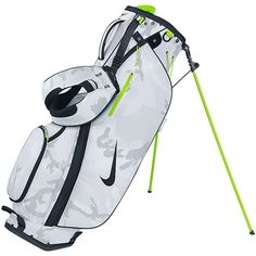 a white golf bag with black and green details on the bottom, in front of a white background