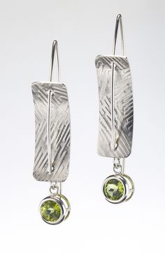 Silver & Stone Earrings - Sterling silver, concave, rectangular earrings pierced by sterling silver ear wires.  A 6mm-round, faceted peridot is bezel-set and dangles from the bottom of the earrings. The sterling-silver rectangles are textured with roller printing. Each pair of earrings is handmade; the texture will vary. Silver Peridot Drop Earrings, Modern Silver Peridot Jewelry, Modern Silver Jewelry With Peridot, Silver Dangle Peridot Earrings, Silver Peridot Dangle Earrings, Pmc Earrings, Rectangular Earrings, Art Jewelry Earrings, Urban Jewelry