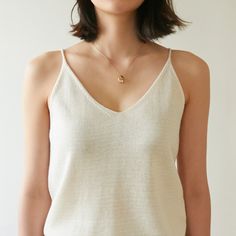 Sleeveless linen knit tank, perfectly worn in shirt with high quality stitching. Feels soft to the touch and is perfect for summer. Model is wearing MINUSEY ONE SIZE. Please allow 5-12 days shipping when in restocking.* MINUSEY ONE SIZE = EU 34-38, US 2-6* 60% Linen / 20% Rayon / 20% Acrylic* Dry clean* Made in Korea - Model Height: 171cm/5'7" (US 2, EU 34) Everyday Fine Knit V-neck Tops, Summer Everyday Knit Tank Top, Spring Layering Fine Knit Tank Top, Everyday Summer Knit Tank Top, Summer Linen Knit Top, Minimalist Summer Tank Top For Everyday, Summer Camisole For Everyday Wear, Fine Knit Tops For Layering In Summer, Fine Knit Tops For Summer Layering