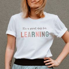 This cute It's a Great Day for Learning tee is a great gift for teachers and learners! Cute for casual Fridays or style it with a cardigan or jacket to dress it up. We love the quality and softness of these Bella Canvas shirts with unisex sizing, and we think you'll love them too! The PRINT This is a Direct-To-Garment printed item which means ink is printed into the fabric. SIZING AND COLORS * This unisex t-shirt feels like a well loved favorite.  * Women should buy their normal size or a smalle School Spirit Cotton T-shirt As Gift, White School Spirit T-shirt For Everyday, Back To School Cotton T-shirt, Educational Graphic Print Crew Neck T-shirt, Back To School Everyday Graphic Print Tops, Everyday Graphic Print Tops For Back To School, Back To School Everyday Crew Neck T-shirt, School Spirit T-shirt With Text Print For Everyday, School Spirit T-shirt With Letter Print As Gift