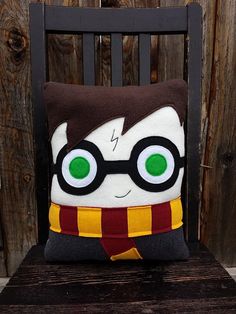 a harry potter pillow sitting on top of a wooden chair