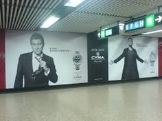 an empty subway station with advertisements on the wall