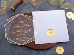 the wedding stationery is laid out on top of an envelope with wax stampers