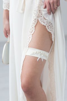 Liumy bridal garter "Champagne Embroidery Flowers" was designed with great attention to details: made from Champagne color fabric and decorated with silk ribbon embroidery, pearl beads and a small ribbon. the base made from elastic fabric so it will feel tight and comfortable on your leg made specially for you! Please leave your leg messurments in the text box bellow packed in beautifull box made from nude colour paper and decorated with gold foil letering and ribbon. So it can be a great presen White Fitted Bridal Belt For Ceremony, Adjustable Bridal Accessories For Ceremony, Adjustable Cream Bridal Accessories For Ceremony, Fitted Bridal Belt With Ribbon For Wedding, Elegant Organza Bridal Accessories For Ceremony, Fitted Cream Bridal Accessories For Ceremony, Adjustable White Bridal Belt For Bridesmaid, Elegant Fitted Bridal Accessories For Wedding Night, Lace Bridal Belt For Ceremony