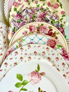 a stack of plates with flowers painted on them