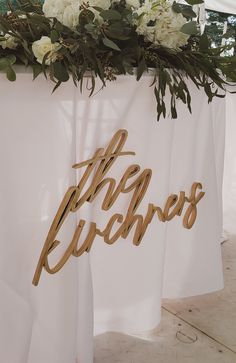 there is a sign that says the bride and grooms next to each other with flowers on it