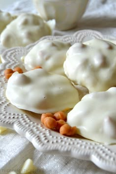 some kind of dessert on a white doily with nuts and icing over it