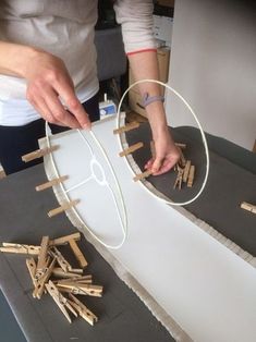 a woman is making something out of sticks