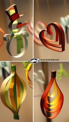 some paper ornaments hanging from the ceiling in different shapes and sizes, all made out of colored