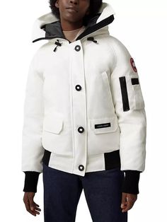 The Canada Goose Chilliwack bomber jacket shields you from extreme cold with sustainable down insulation and a durable wartime-inspired silhouette. Adjustable hood, ample pockets and rib-knit trim enhance comfort. Hooded Winter White Parka With Pockets, Winter White Hooded Parka With Pockets, Hooded Puffer Jacket With Ribbed Cuffs, Hooded Winter White Outerwear With Ribbed Cuffs, White Hooded Jacket With Ribbed Cuffs For Winter, White Long Sleeve Outerwear With Multiple Pockets, Hooded Parka With Ribbed Cuffs For Cold Weather, Urban White Parka For Fall, Hooded Outerwear With Ribbed Cuffs For Cold Weather