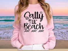 Looking for a funny gift for her? This Salty Lil Beach Sweatshirt is for you! Perfect Mother's Day gift for mom, sister, girlfriend or wife or for women who love the beach and the summer! This salty sweatshirt makes the perfect gift for her for birthday, graduation, and more.. This cute summer sweatshirt is a super sooooft and oh so comfy high quality unisex sweatshirt. It makes THE PERFECT go-to sweatshirt all summer season long. All colors are a 50 cotton/50 poly blend and runs true to size. T Long Sleeve Tops With Letter Print For Beach Season, Holiday Crew Neck Tops For Beach Season, Holiday Beach Tops With Letter Print, Letter Print Tops For Beach Holiday, Crew Neck Tops For Beach Season Holiday, Pink Letter Print Sweatshirt For Vacation, Pink Sweatshirt For Summer Vacation, Funny Be Salty Gifts, Salty Days Sweater