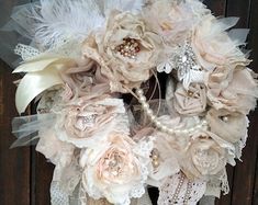 a bridal bouquet with feathers and pearls